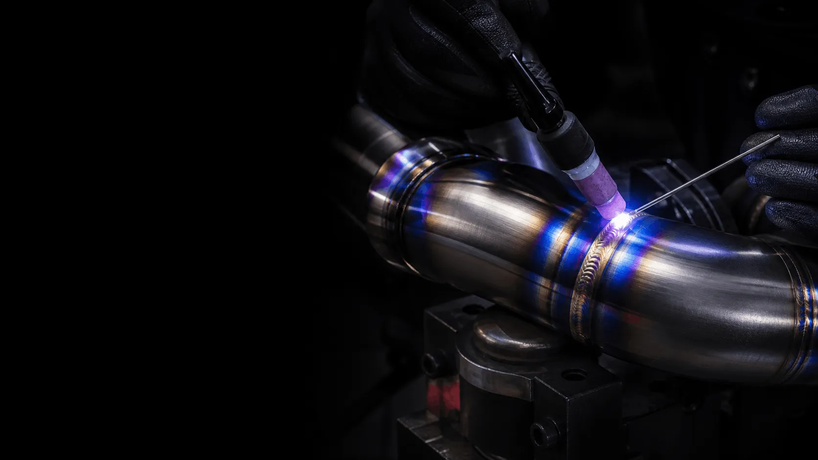 High-performance titanium exhaust pipe during precision TIG welding